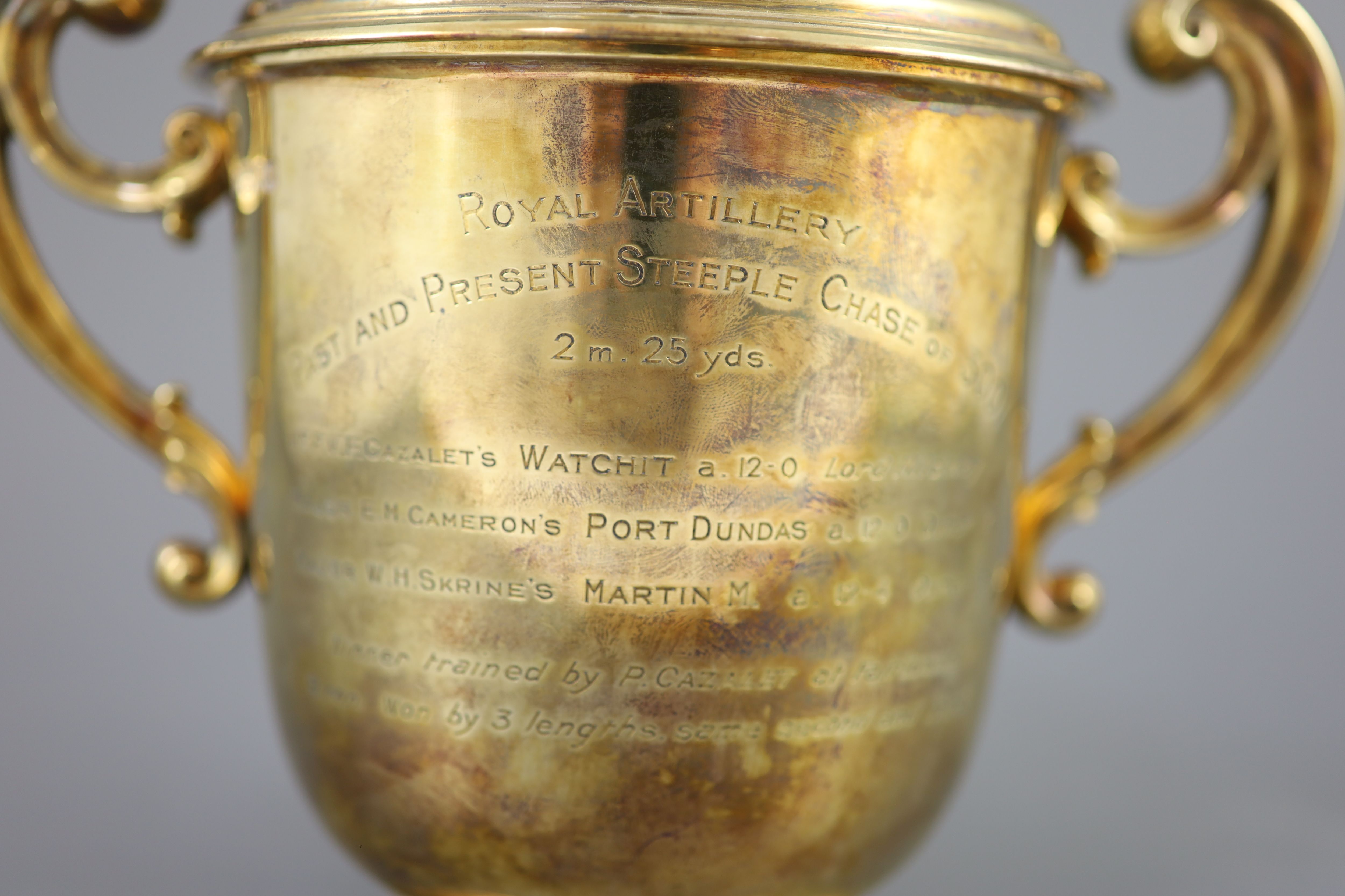 An Edwardian silver gilt-lidded two handled presentation cup and cover, by R & S Garrard and Co.
